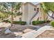 Inviting condo exterior featuring manicured bushes, tidy landscaping and a private entrance at 6480 Annie Oakley Dr # 314, Las Vegas, NV 89120