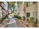 Charming condo exterior featuring lush greenery, mature trees and a well-maintained landscape at 6480 Annie Oakley Dr # 314, Las Vegas, NV 89120