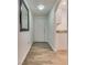 Clean condo hallway with wood floors, leading to a kitchen with granite counters at 6480 Annie Oakley Dr # 314, Las Vegas, NV 89120