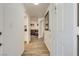 Bright condo hallway featuring modern wood floors leading to a cozy living area with ample natural light at 6480 Annie Oakley Dr # 314, Las Vegas, NV 89120