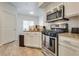 Kitchen boasts stainless steel appliances, granite countertops, and white cabinets at 6480 Annie Oakley Dr # 314, Las Vegas, NV 89120