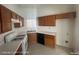 Practical kitchen featuring wood cabinetry, white countertops, and updated appliances for a convenient cooking experience at 6512 Sterling Springs Pkwy, Las Vegas, NV 89108