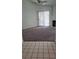 Inviting living room featuring plush carpeting, a ceiling fan, and sliding glass doors to the exterior at 6512 Sterling Springs Pkwy, Las Vegas, NV 89108