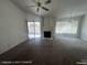 Bright and spacious living area with a fireplace, ceiling fan, and sliding doors leading to the backyard at 6512 Sterling Springs Pkwy, Las Vegas, NV 89108