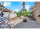 Backyard patio featuring palm trees, patio furniture, and a fire pit at 6631 Creeping Thyme St, Las Vegas, NV 89148