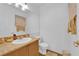 Clean bathroom with a granite countertop, white fixtures, and a framed mirror at 6631 Creeping Thyme St, Las Vegas, NV 89148