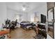 Bright bedroom with wood floors, ceiling fan, and natural light from the window at 6631 Creeping Thyme St, Las Vegas, NV 89148