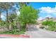 Charming single-story home featuring a neutral color palette, mature trees, and a two-car garage at 6631 Creeping Thyme St, Las Vegas, NV 89148