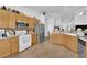 Spacious kitchen with light wood cabinets, granite countertops, and stainless steel appliances at 6631 Creeping Thyme St, Las Vegas, NV 89148