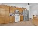 Well-lit kitchen featuring ample light wood cabinetry, granite countertops, and modern appliances at 6631 Creeping Thyme St, Las Vegas, NV 89148