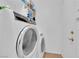 Laundry room featuring modern front load washer and dryer, and tile floors at 6631 Creeping Thyme St, Las Vegas, NV 89148