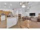 Open-concept living room with vaulted ceilings, modern lighting, and seamless flow to the kitchen at 6631 Creeping Thyme St, Las Vegas, NV 89148