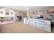 Spacious, brightly-lit room featuring lots of storage, desk space and decorative doll house at 6713 Guidestar St, North Las Vegas, NV 89084