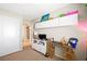 Bedroom featuring light tan walls, a desk area and white shelving at 6713 Guidestar St, North Las Vegas, NV 89084