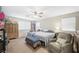 Comfortable bedroom featuring a ceiling fan, natural light, and a neutral color palette for a relaxing ambiance at 6713 Guidestar St, North Las Vegas, NV 89084