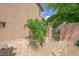 Side view of the home's stucco exterior with a gated yard and desert landscaping at 6713 Guidestar St, North Las Vegas, NV 89084