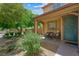 Inviting front porch with seating area, lush greenery, and a charming front door, creating a warm welcome at 6713 Guidestar St, North Las Vegas, NV 89084