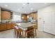Bright kitchen featuring wooden cabinets, granite counters, a large island with seating, and stainless appliances at 6713 Guidestar St, North Las Vegas, NV 89084
