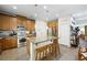Bright kitchen featuring stainless steel appliances, wooden cabinets, and an island with bar stool seating at 6713 Guidestar St, North Las Vegas, NV 89084