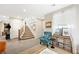 Cozy living room with stairs and stylish furnishings, large bookshelf, and ample natural light at 6713 Guidestar St, North Las Vegas, NV 89084