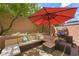 Cozy patio with comfortable sectional seating and shade umbrella for outdoor relaxation at 6713 Guidestar St, North Las Vegas, NV 89084