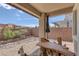 Charming backyard with unique wooden furniture, rock landscaping, and private patio area at 6934 Alexandrite Peak St, Las Vegas, NV 89148