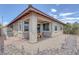 Well-maintained backyard featuring a cozy patio area, lush plants, and serene gravel landscaping at 6934 Alexandrite Peak St, Las Vegas, NV 89148