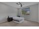 Bright bedroom with a ceiling fan, window, and neutral carpet at 6934 Alexandrite Peak St, Las Vegas, NV 89148