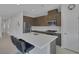 Modern kitchen with stainless appliances, a white island, and barstool seating at 6934 Alexandrite Peak St, Las Vegas, NV 89148