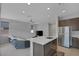 Spacious kitchen with stainless appliances, an island, and seamless flow into the living area at 6934 Alexandrite Peak St, Las Vegas, NV 89148