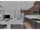 Open-concept kitchen with stainless steel appliances, an island, and sleek countertops at 6934 Alexandrite Peak St, Las Vegas, NV 89148