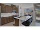 Modern kitchen boasts stainless appliances, an island with seating, and abundant cabinetry at 6934 Alexandrite Peak St, Las Vegas, NV 89148