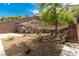 Backyard showcasing a rock retaining wall and terraced landscaping at 71 Blaven Dr, Henderson, NV 89002