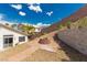 Backyard features a fire pit, terraced landscaping, and block retaining wall at 71 Blaven Dr, Henderson, NV 89002
