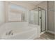 A bathroom featuring a tub, a shower and a window at 71 Blaven Dr, Henderson, NV 89002