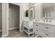 Bathroom includes double sinks, a shower, and wood look flooring at 71 Blaven Dr, Henderson, NV 89002