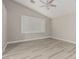 Vaulted ceiling bedroom with ceiling fan, plantation shutters, and light wood flooring at 71 Blaven Dr, Henderson, NV 89002