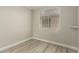 Neutral bedroom featuring wood-look flooring and a bright window at 71 Blaven Dr, Henderson, NV 89002