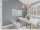 Bright dining room featuring a white table, modern light fixture and elegant decor at 71 Blaven Dr, Henderson, NV 89002