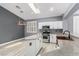 Well-lit kitchen featuring an island, stainless steel appliances, a skylight, and stylish countertops at 71 Blaven Dr, Henderson, NV 89002