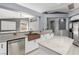 Contemporary kitchen featuring stainless steel appliances, a center island, and a view into the living area at 71 Blaven Dr, Henderson, NV 89002
