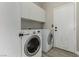 Laundry room features washer, dryer, cabinets, and exterior access at 71 Blaven Dr, Henderson, NV 89002
