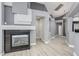 Contemporary living room showcasing a unique fireplace, modern flooring, and an open layout to the kitchen at 71 Blaven Dr, Henderson, NV 89002