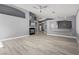 Open-concept living room with a modern fireplace, stylish flooring, and an adjacent kitchen area at 71 Blaven Dr, Henderson, NV 89002