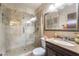 Bathroom with a glass enclosed shower featuring stone tile work and a dark wood vanity with a marble countertop at 750 S Royal Crest Cir # 317, Las Vegas, NV 89169