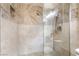 Walk-in shower showcases beautiful stone tiling and a glass enclosure with a rainfall shower head at 750 S Royal Crest Cir # 317, Las Vegas, NV 89169