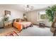Bright bedroom featuring neutral walls, a ceiling fan, bedside tables and large window with sheer curtains at 750 S Royal Crest Cir # 317, Las Vegas, NV 89169