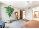 Inviting bedroom with a tall potted plant, wall art and door to the en suite bathroom at 750 S Royal Crest Cir # 317, Las Vegas, NV 89169