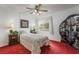 Bright bedroom featuring plush red carpeting, a ceiling fan, and a charming oriental screen adding character at 750 S Royal Crest Cir # 317, Las Vegas, NV 89169