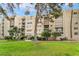Beautiful view of condo building with well maintained grounds and manicured trees and bushes at 750 S Royal Crest Cir # 317, Las Vegas, NV 89169